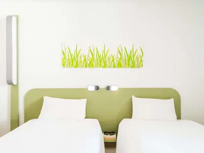 Un ou plusieurs lits dans un hébergement de l'établissement ibis Budget Courbevoie Paris La Défense