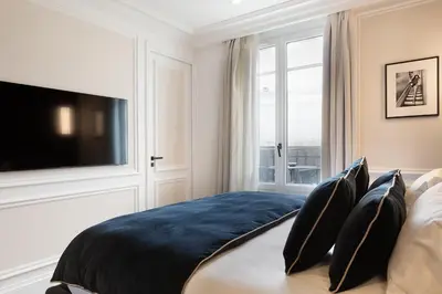 Un ou plusieurs lits dans un hébergement de l'établissement TheLander - Serviced Apartments in Champs Elysées