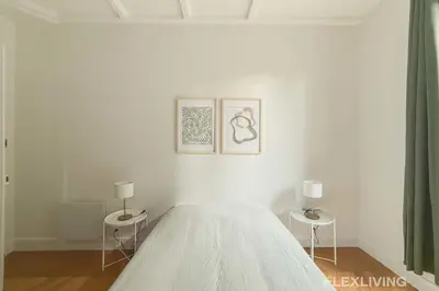 Un ou plusieurs lits dans un hébergement de l'établissement Spacious 3-bedroom apartment in Paris 14 - Alésia
