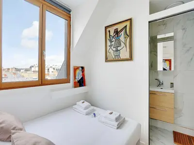 Un ou plusieurs lits dans un hébergement de l'établissement Cosy appt 1BDR 2P - Arc de Triomphe