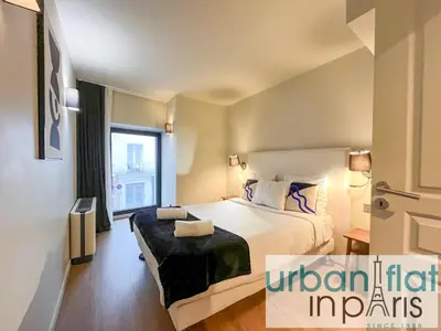 Un ou plusieurs lits dans un hébergement de l'établissement Urban Flat 133 - Ponceau 4 Bedroom Apartment