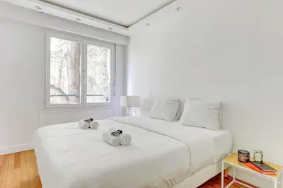 Un ou plusieurs lits dans un hébergement de l'établissement Appartement chic 82m2 6 pers Paris 16E