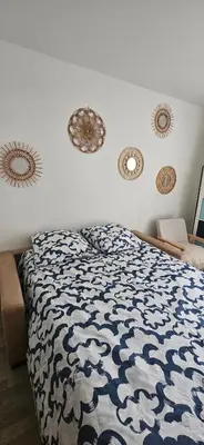 Un ou plusieurs lits dans un hébergement de l'établissement Une chambre douillette à Stade de France