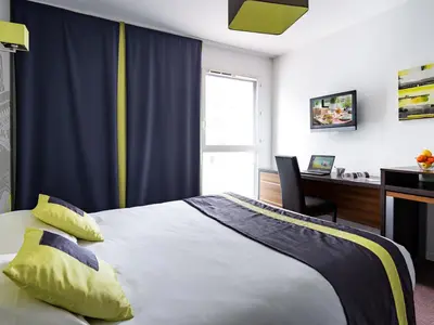 Un ou plusieurs lits dans un hébergement de l'établissement Lagrange Apart’Hotel Paris-Boulogne