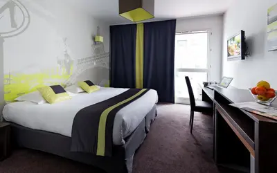 Un ou plusieurs lits dans un hébergement de l'établissement Lagrange Apart’Hotel Paris-Boulogne
