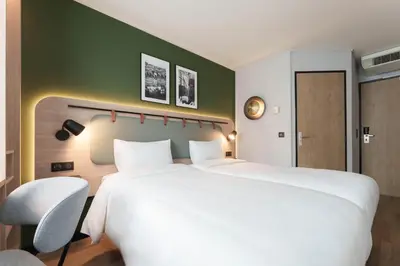 Un ou plusieurs lits dans un hébergement de l'établissement Campanile Prime Paris 19 - La Villette