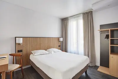 Un ou plusieurs lits dans un hébergement de l'établissement Hotel Gabriel Issy Paris