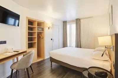 Un ou plusieurs lits dans un hébergement de l'établissement Hotel Gabriel Issy Paris