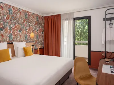 Un ou plusieurs lits dans un hébergement de l'établissement Hôtel Mercure Paris Boulogne Pont de Saint Cloud