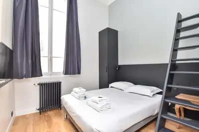 Un ou plusieurs lits dans un hébergement de l'établissement Cosy apartment - 2BR-7P - Arc de Triomphe